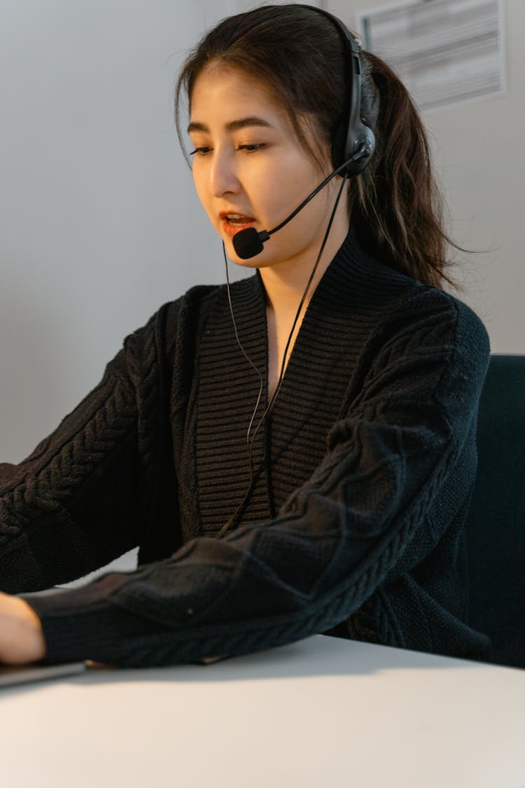 A Woman Talking On A Headset