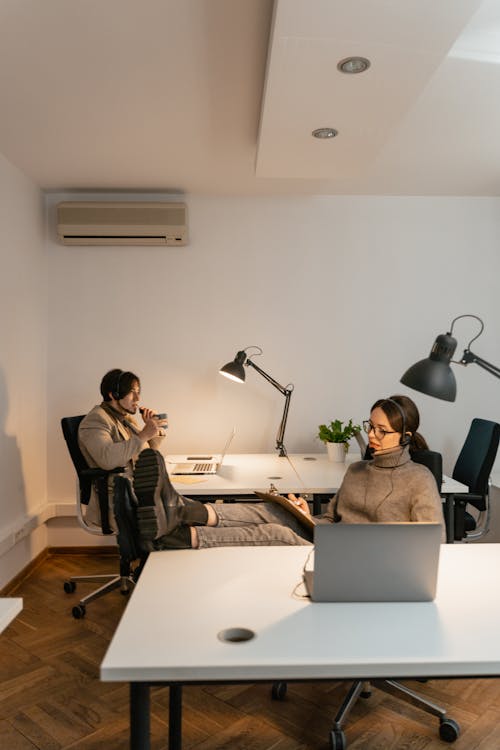Free A Man and a Woman Working at the Office Stock Photo