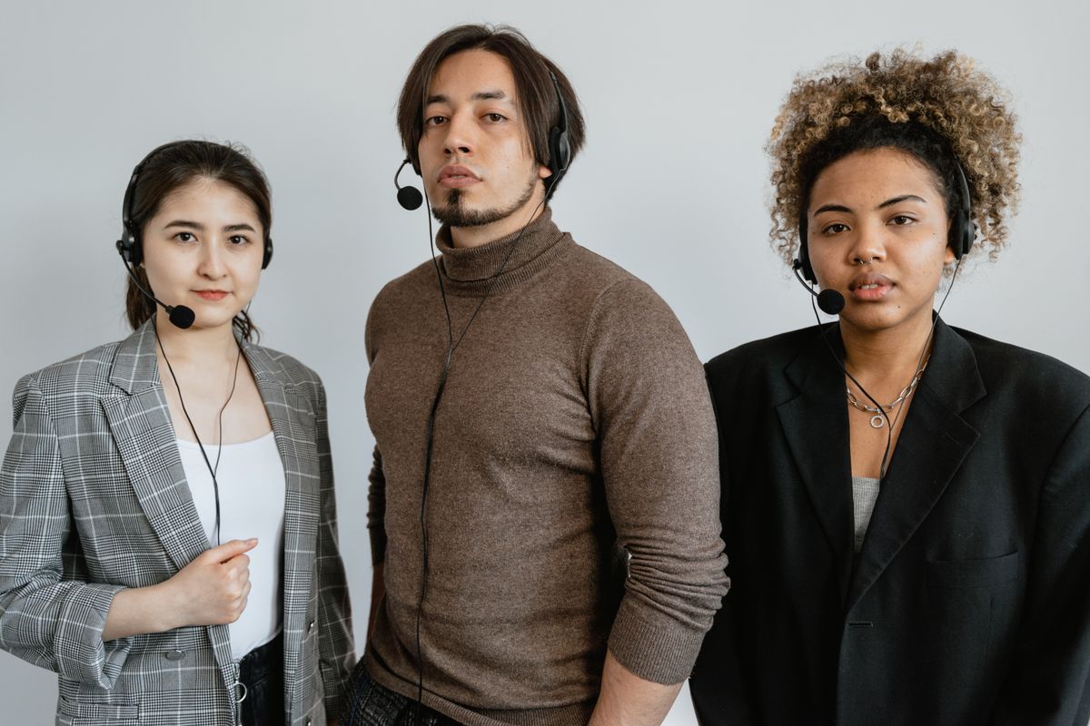Customer support professionals wearing headsets in a modern office