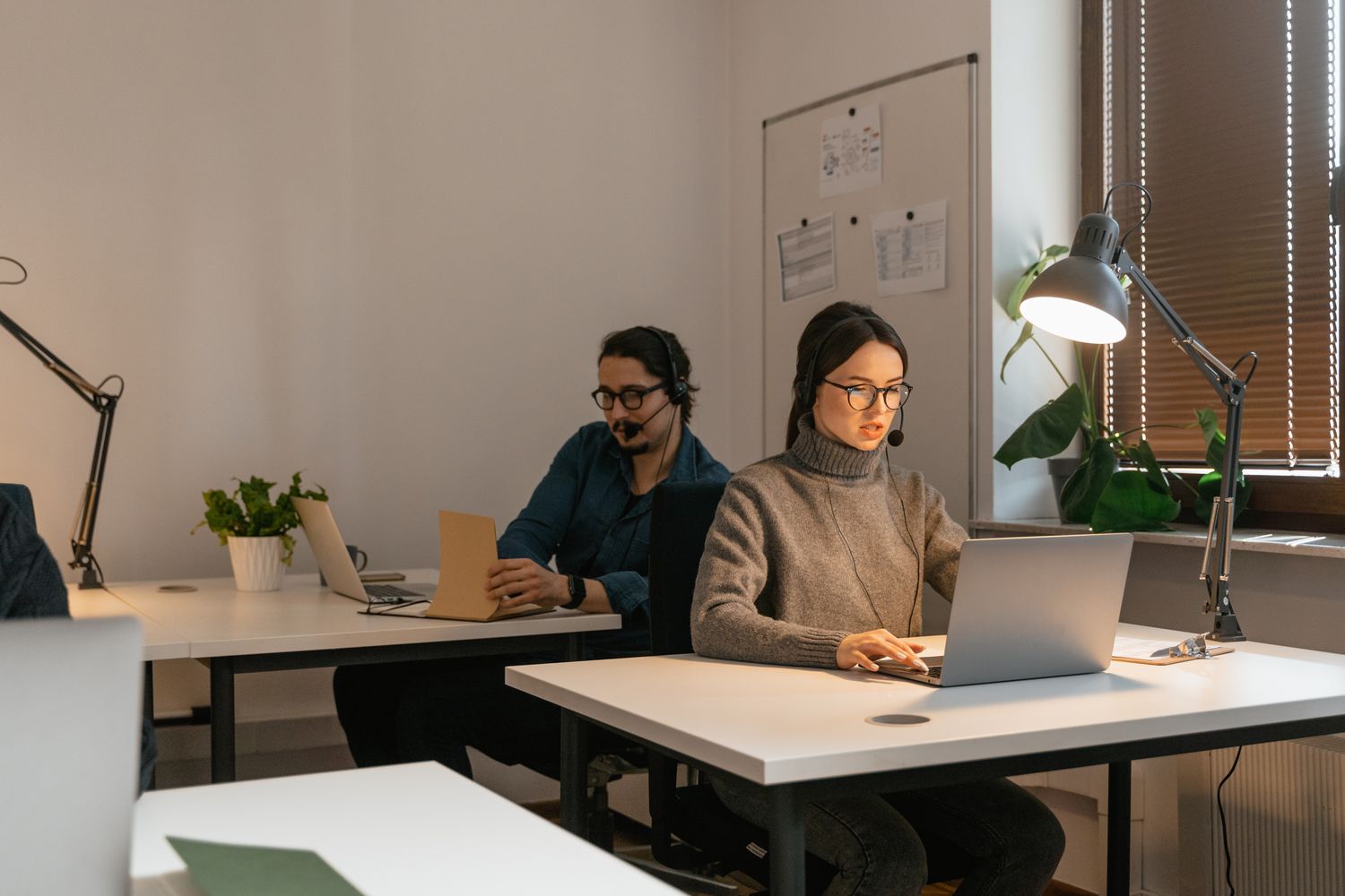 Two colleagues working together on customer inquiries in an office