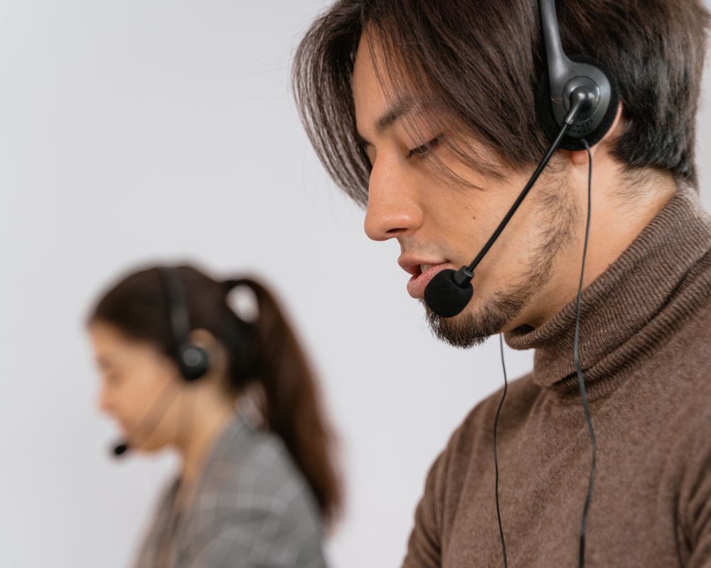 Customer support professional wearing a headset assisting customers