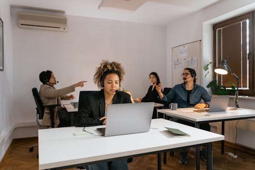 A diverse team in an office setting working together in a modern call center.