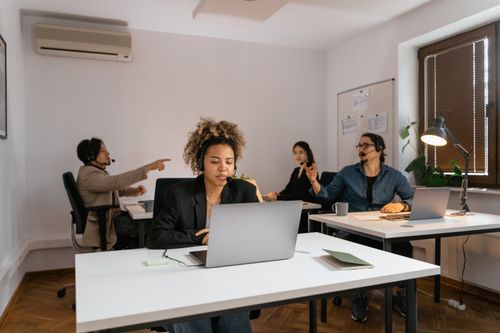 Free A diverse team in an office setting working together in a modern call center. Stock Photo