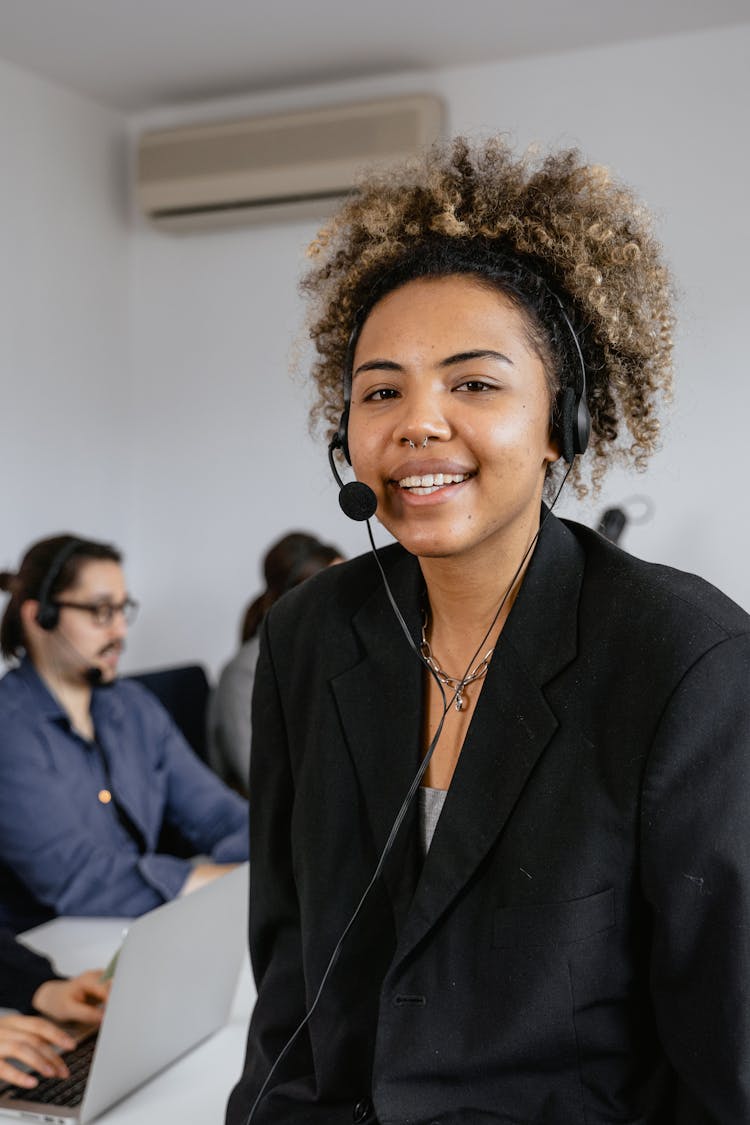 A Woman In A Blazer Wearing A Headset