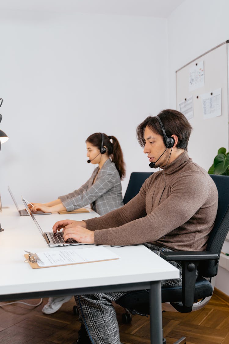 A Man And A Woman Working In An Office