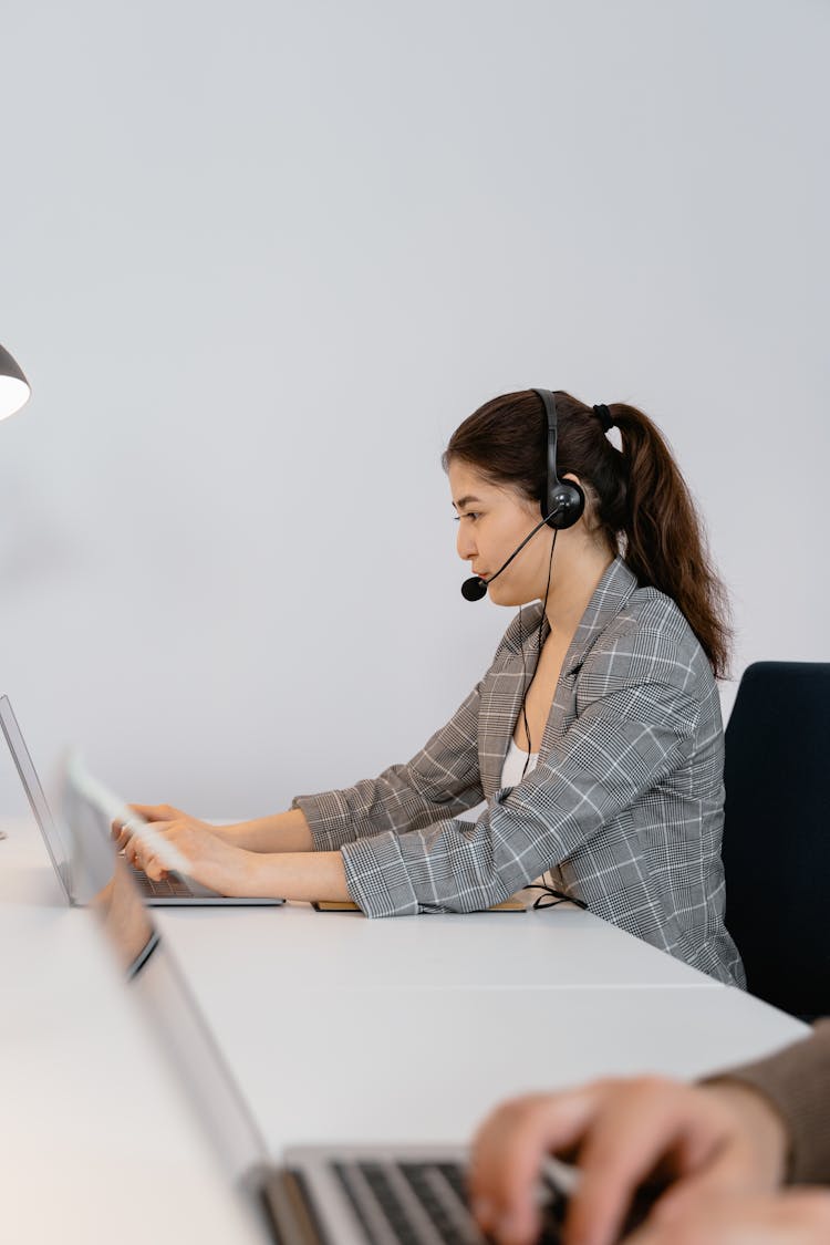 Woman In Gray And White Blazer Using Laptop