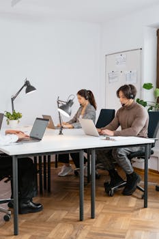 Business call center team focused on customer service with modern office setup.