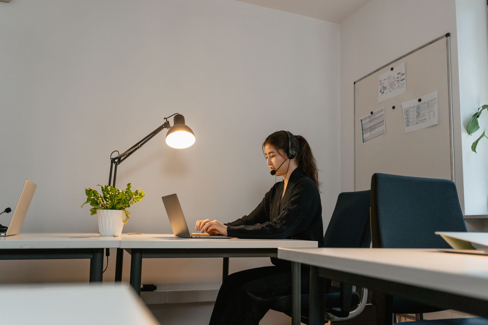 Professional virtual assistant working on a laptop