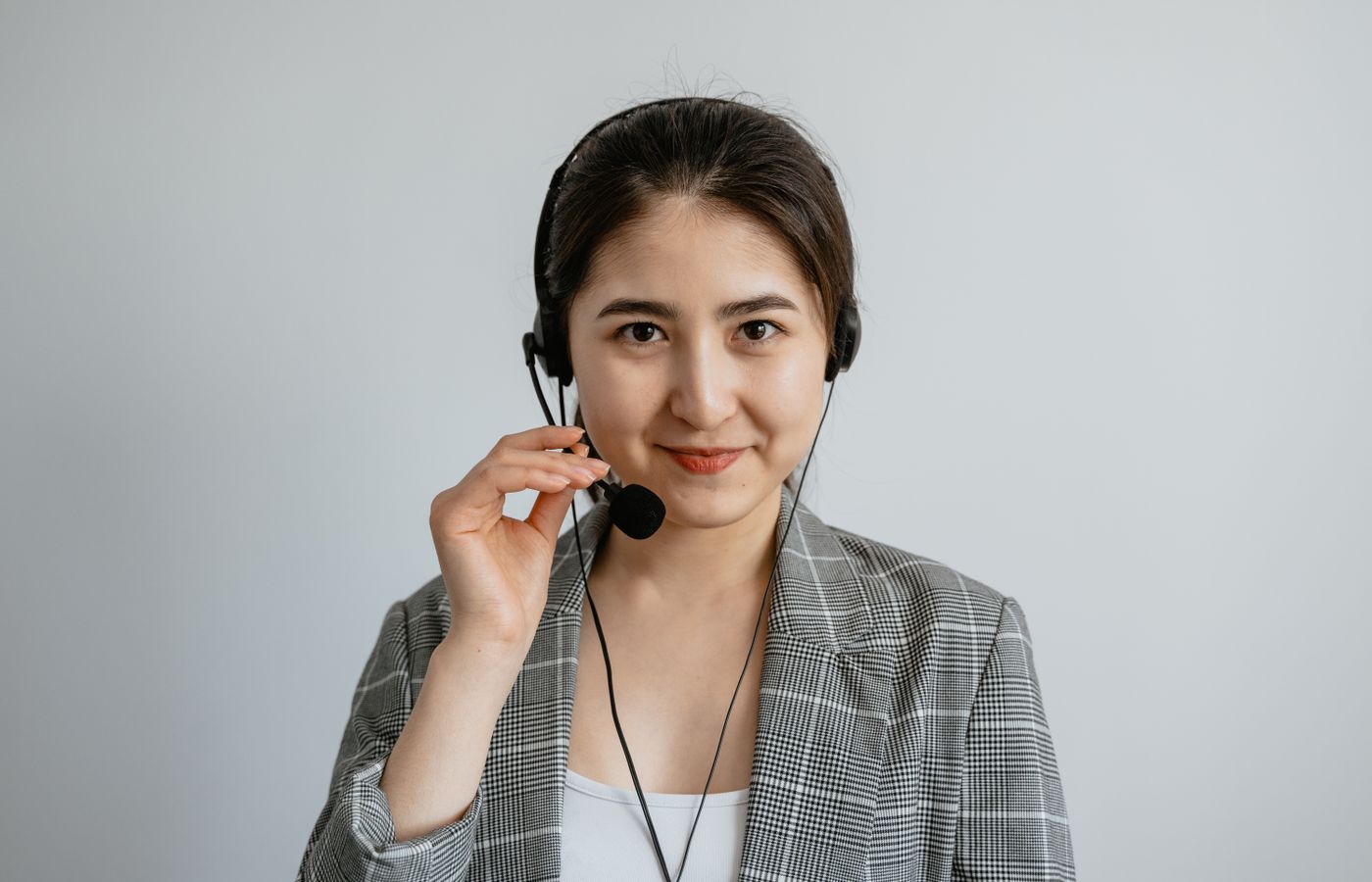 Portrait of a young call center agent confidently working with a headset.