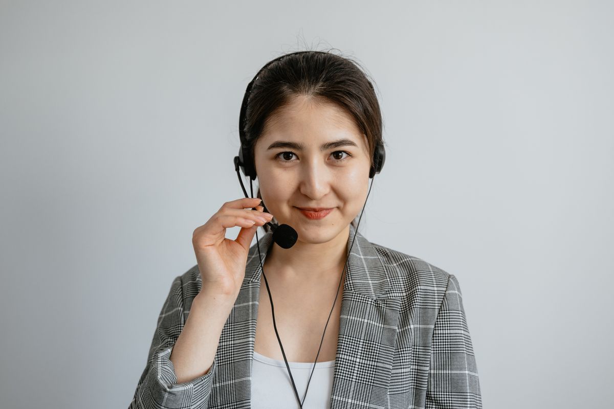 IT support specialist assisting a user by headset