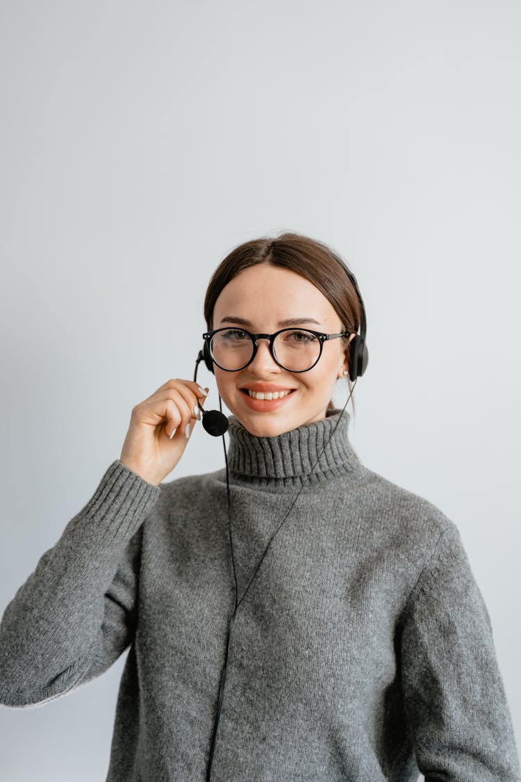 Woman In Gray Turtle Neck Shirt With Black Headset And Mouthpiece