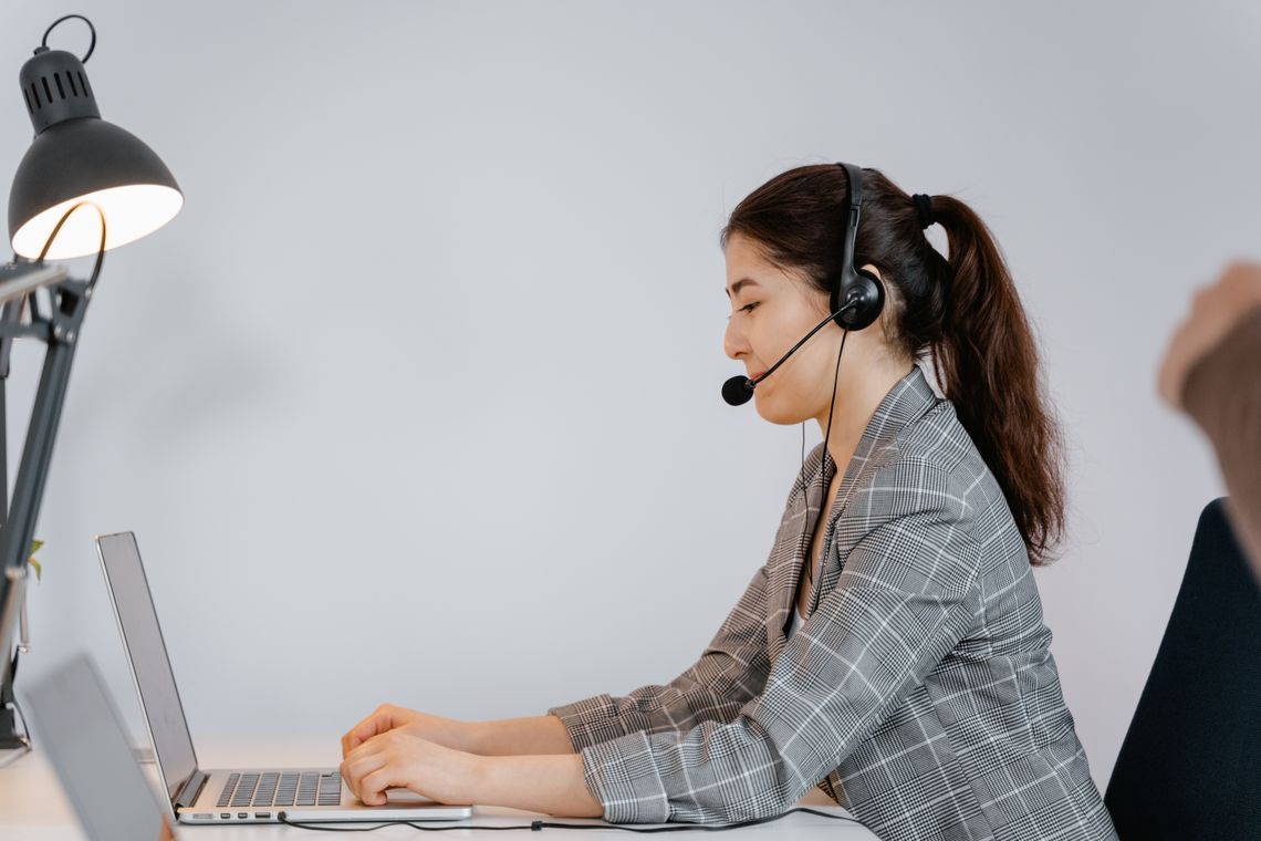 Customer support professional assisting a customer from a laptop