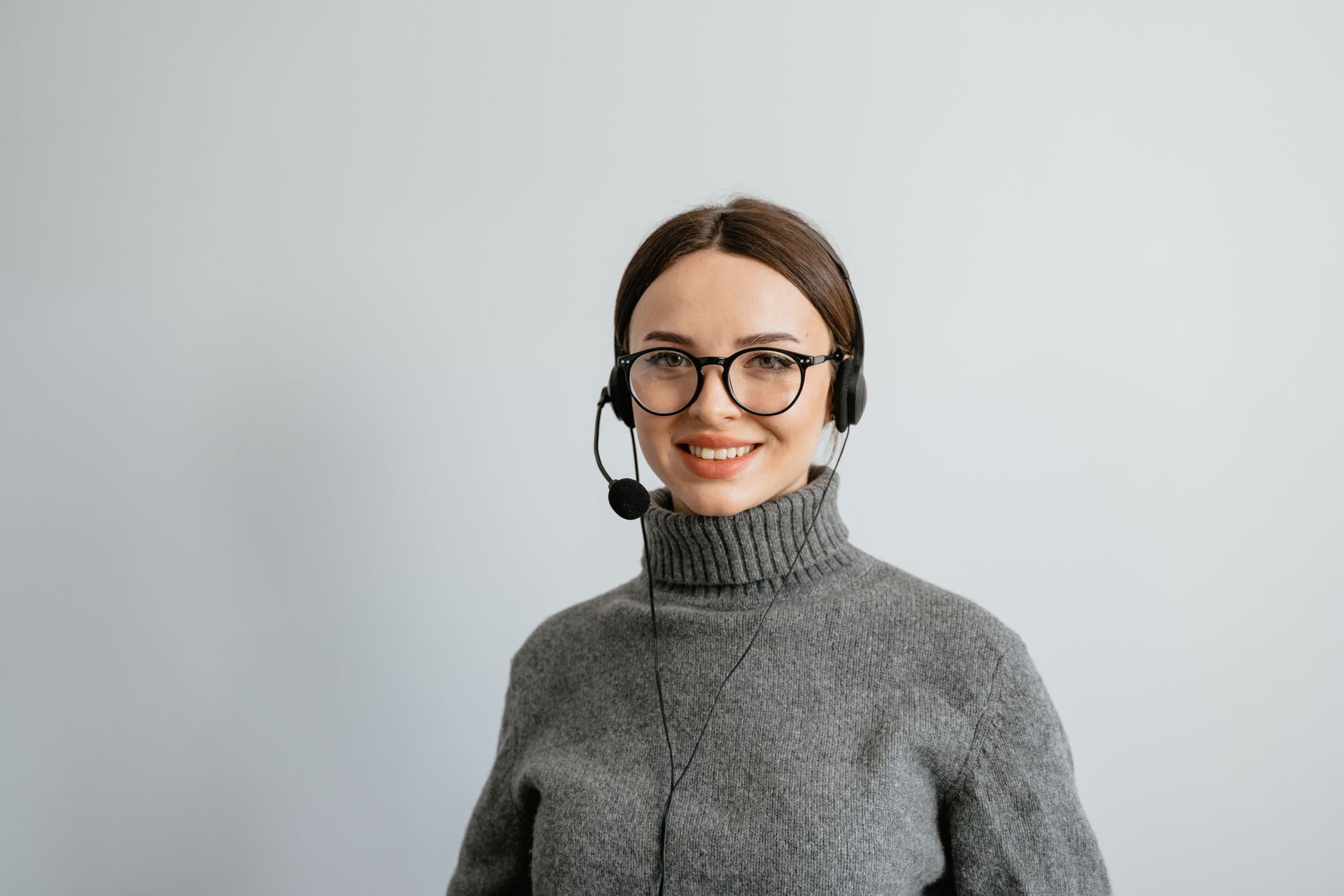customer service representative monitoring AI voice assistant dashboard with real-time analytics