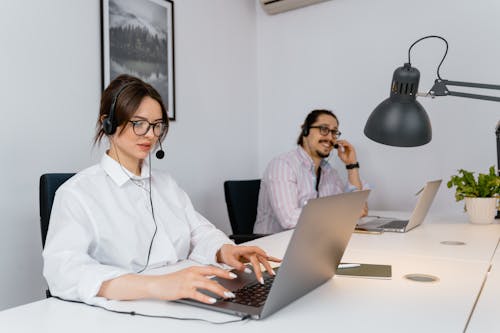 Free A Man and a Woman Working in an Office Stock Photo
