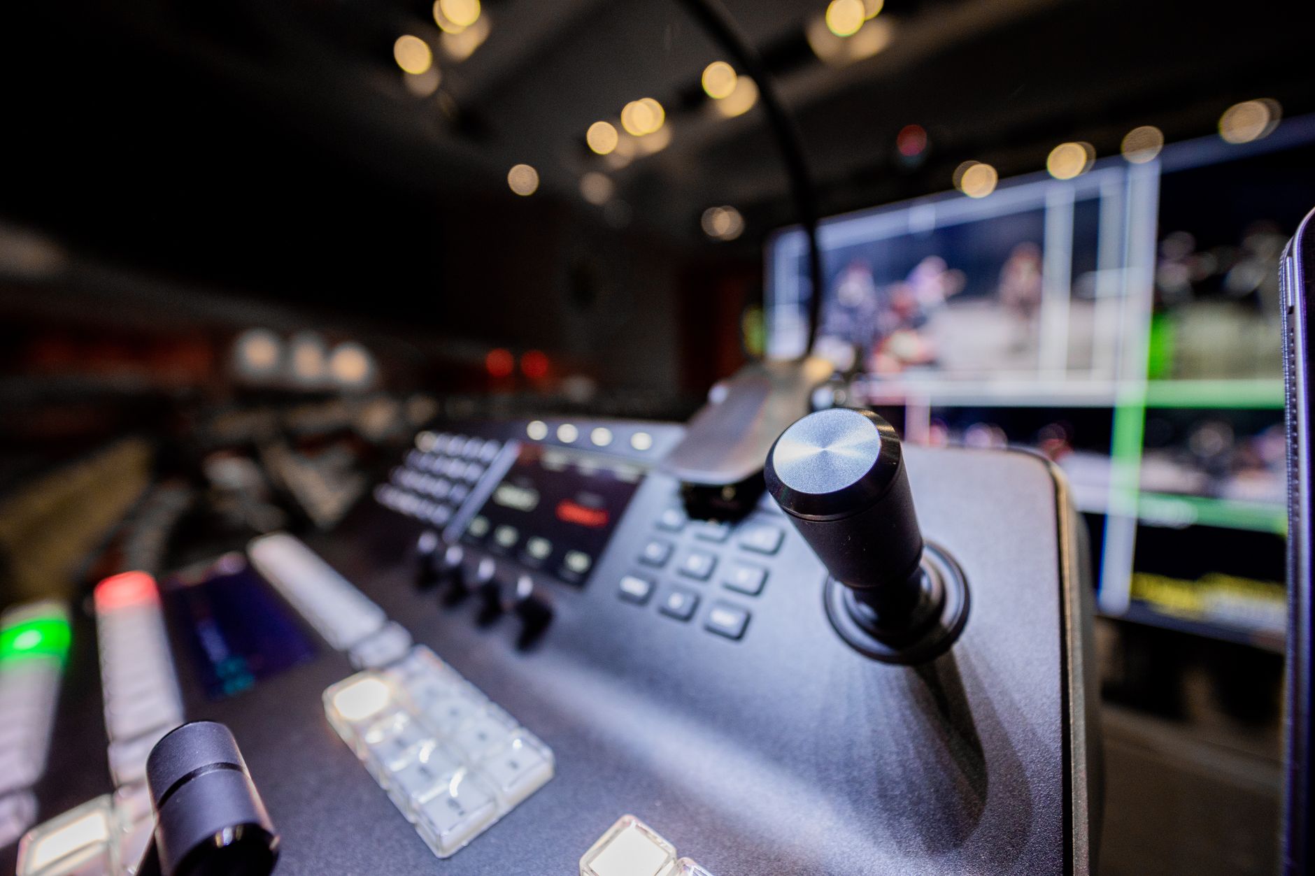 VAR control room with multiple football match feeds, officials comparing angles on illuminated monitors