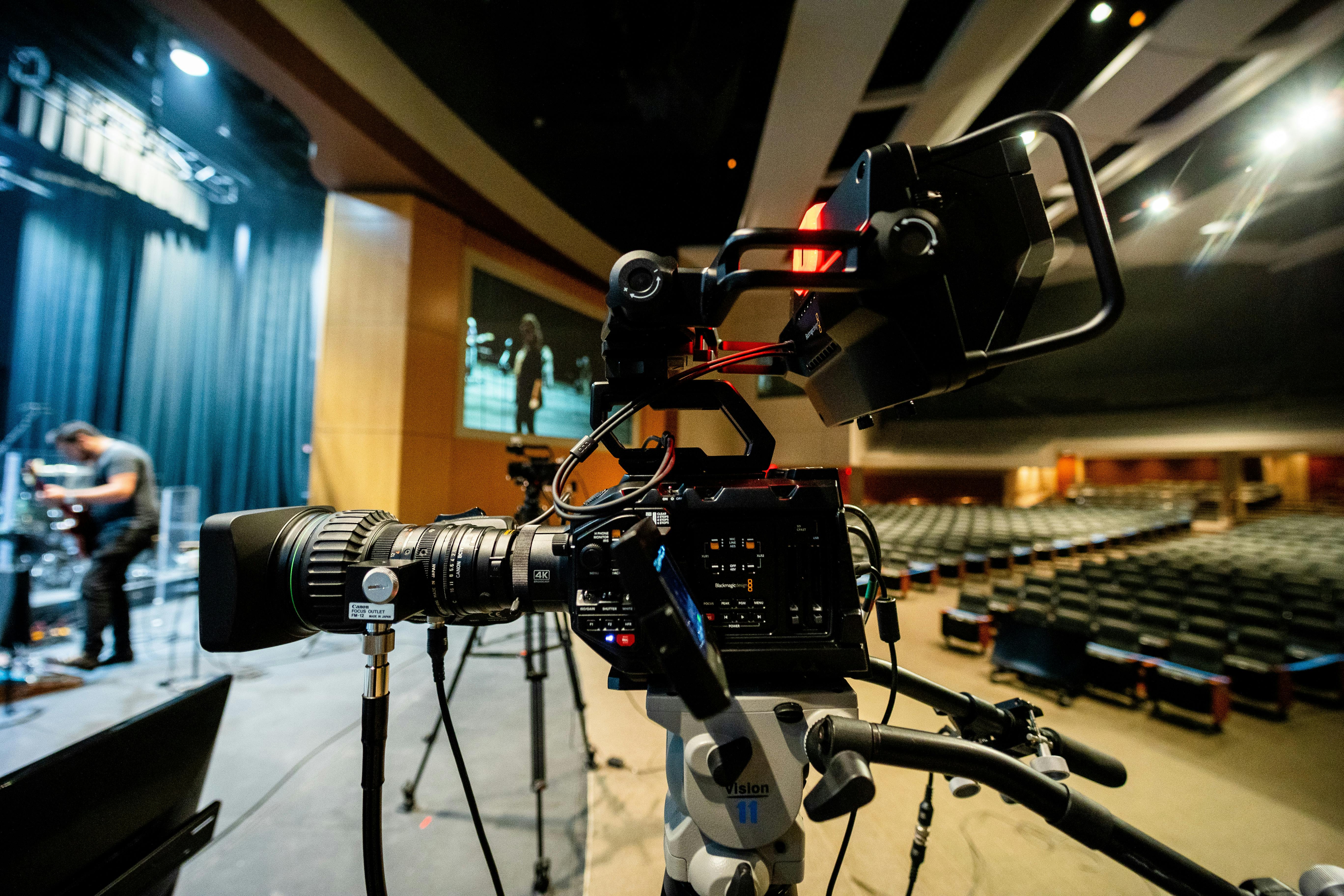 professional camera recording video near stage