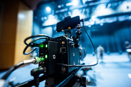 Free Professional black video camera with wires located in professional recording studio during process of filming Stock Photo