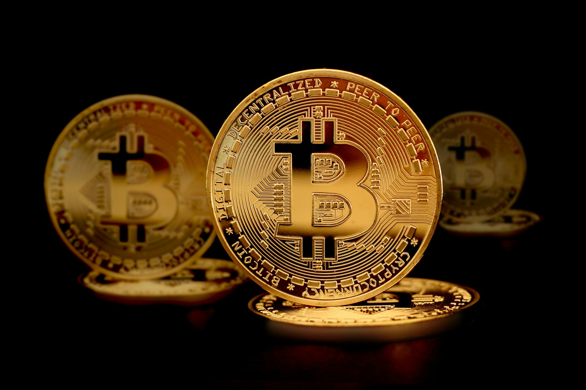 Close-Up Photograph of Gold Coins on a Black Surface