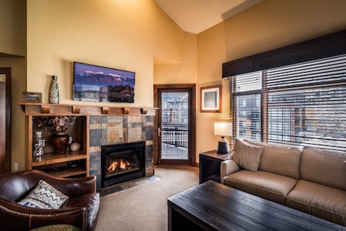 A Classy Carpeted Living Room with a Fire Place