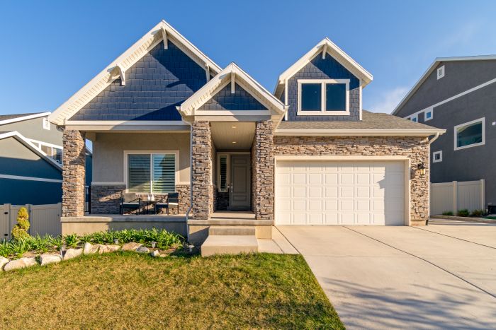 Modern suburban home with a stone facade and a neatly kept lawn — photo by Get Lost Mike on Pexels