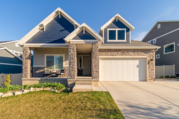 White And Brown Concrete House Under Blue Sky