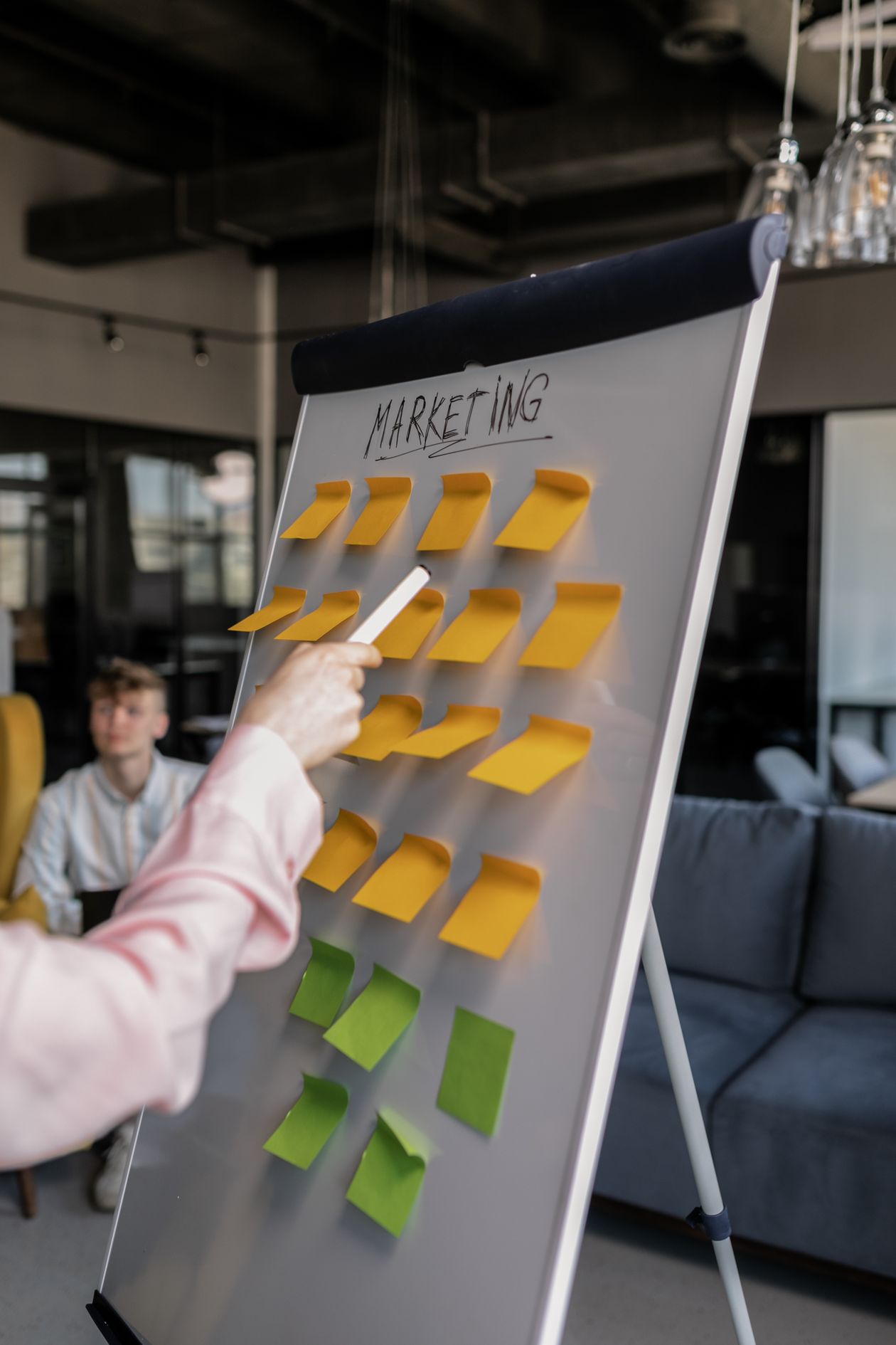 Facilitator mapping a business process on a whiteboard with sticky notes during an AI agent mapping session