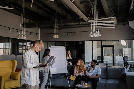 A diverse group of professionals collaborating during a business meeting in an open-plan office.