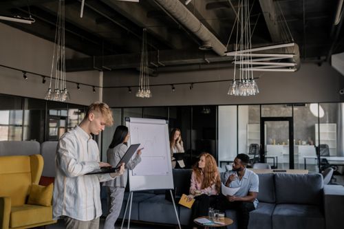 Free A diverse group of professionals collaborating during a business meeting in an open-plan office. Stock Photo