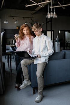 Caucasian coworkers discussing a project in a modern office setting.