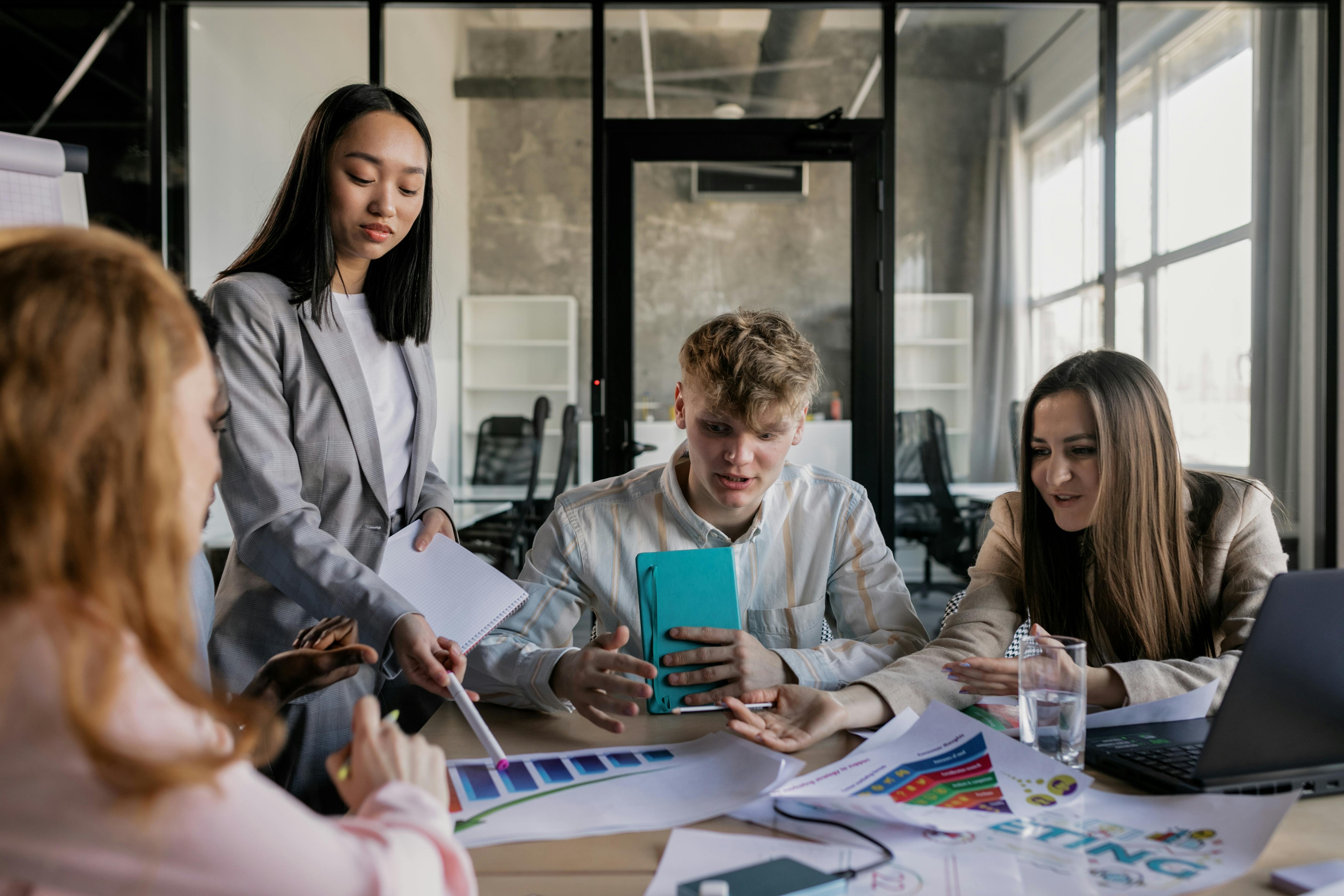 a group of people having a meeting in the office