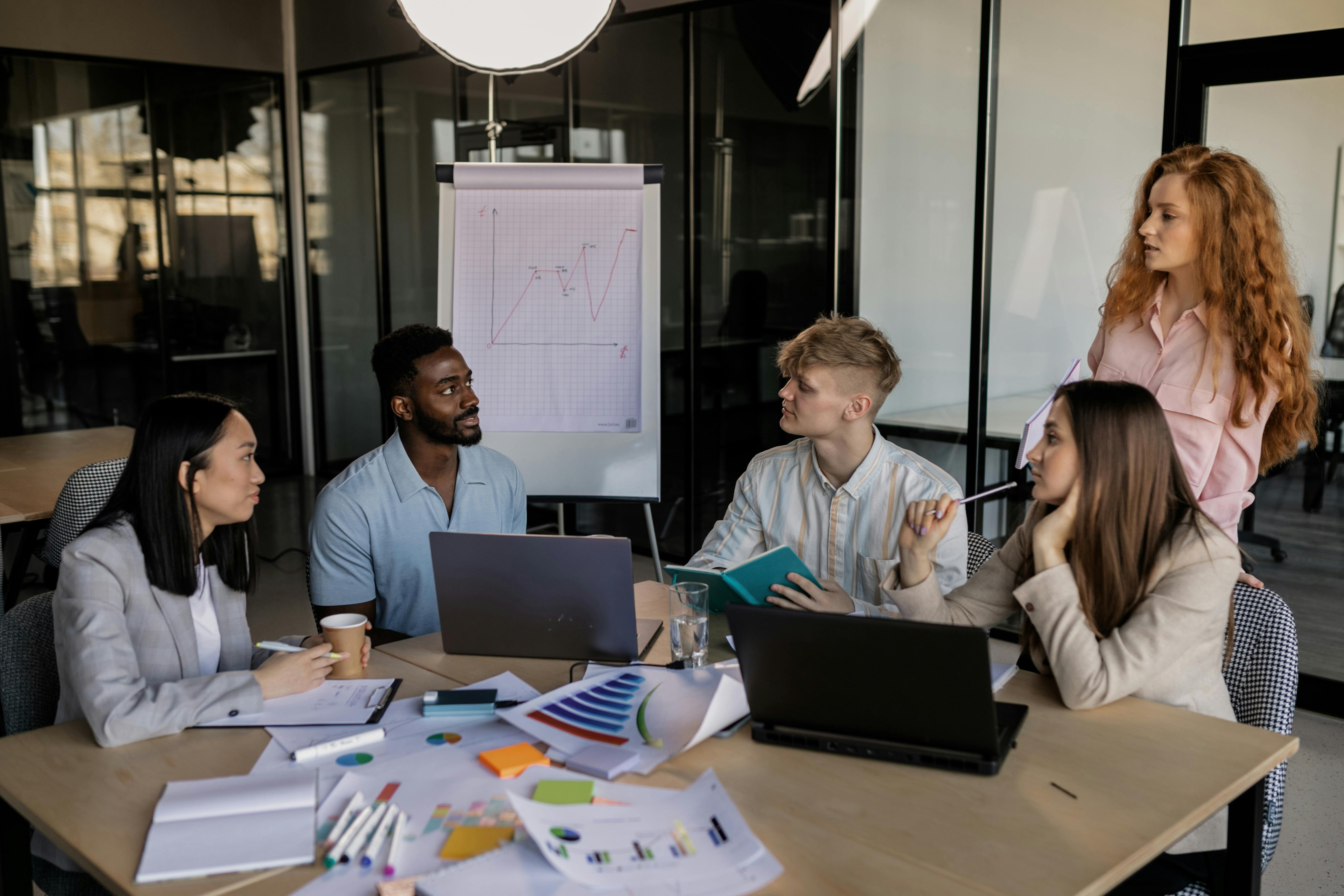 a group of people having a meeting in the office