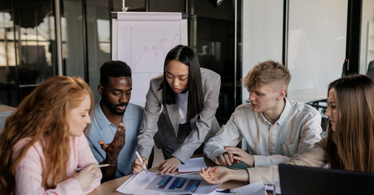 Photo by Alena Darmel A diverse group of professionals engaged in a collaborative business strategy meeting in a modern office.