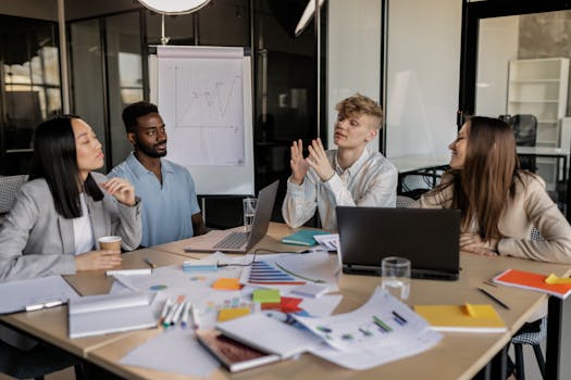 A diverse group of colleagues collaborating on a business strategy in a modern office setting.