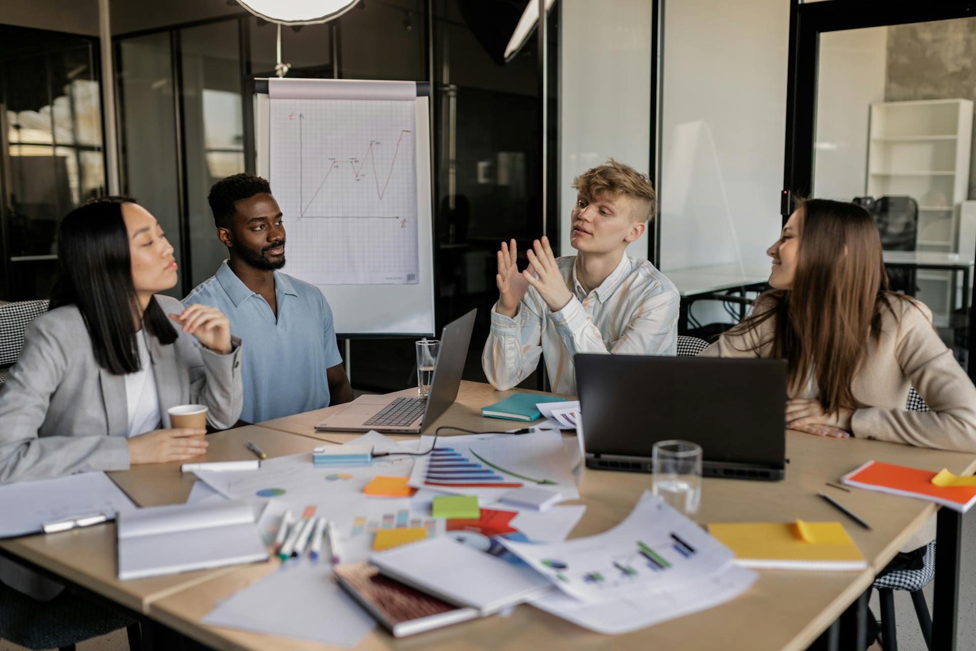 A diverse group of colleagues collaborating on a business strategy in a modern office setting.