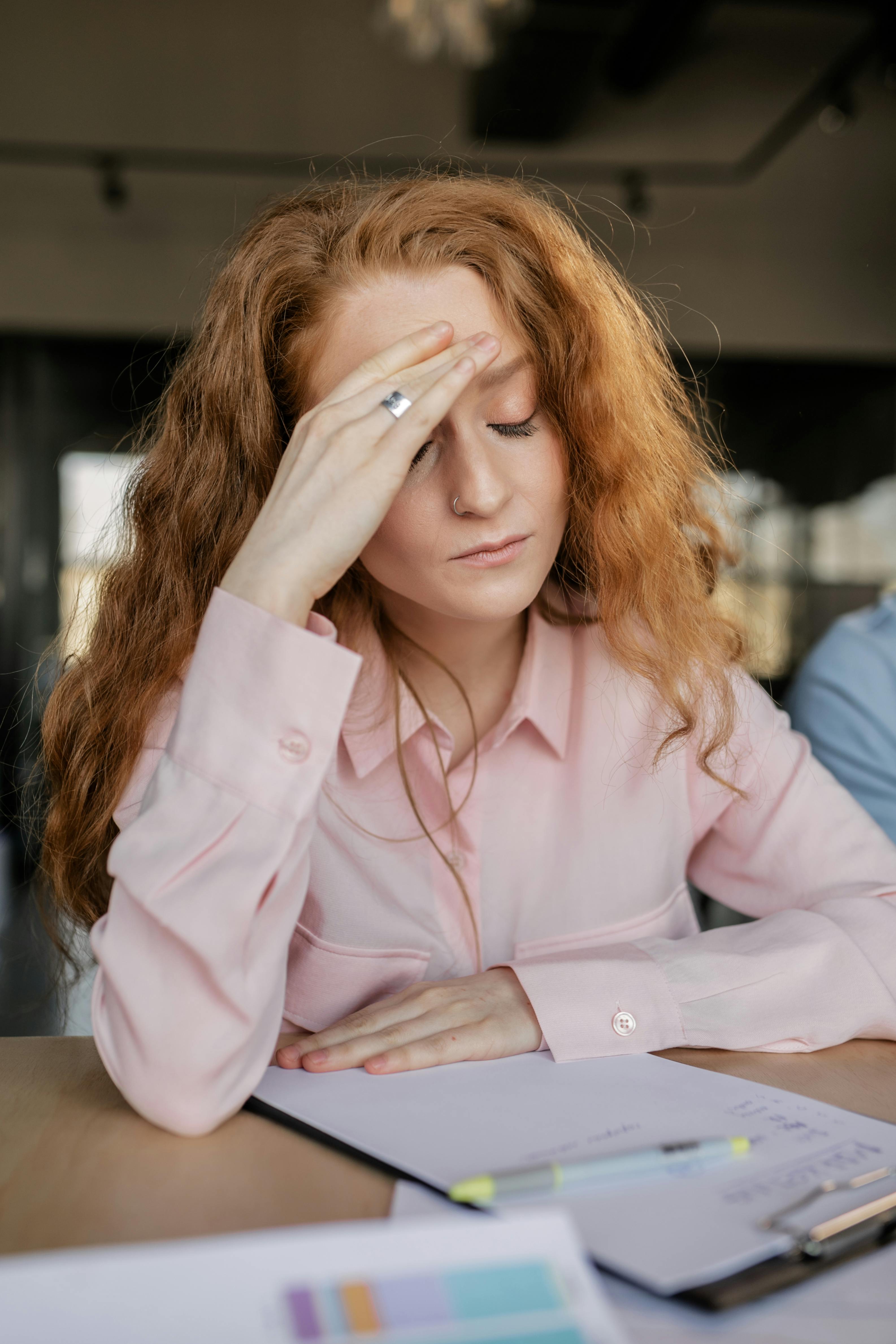 Woman Holding Her Head · Free Stock Photo