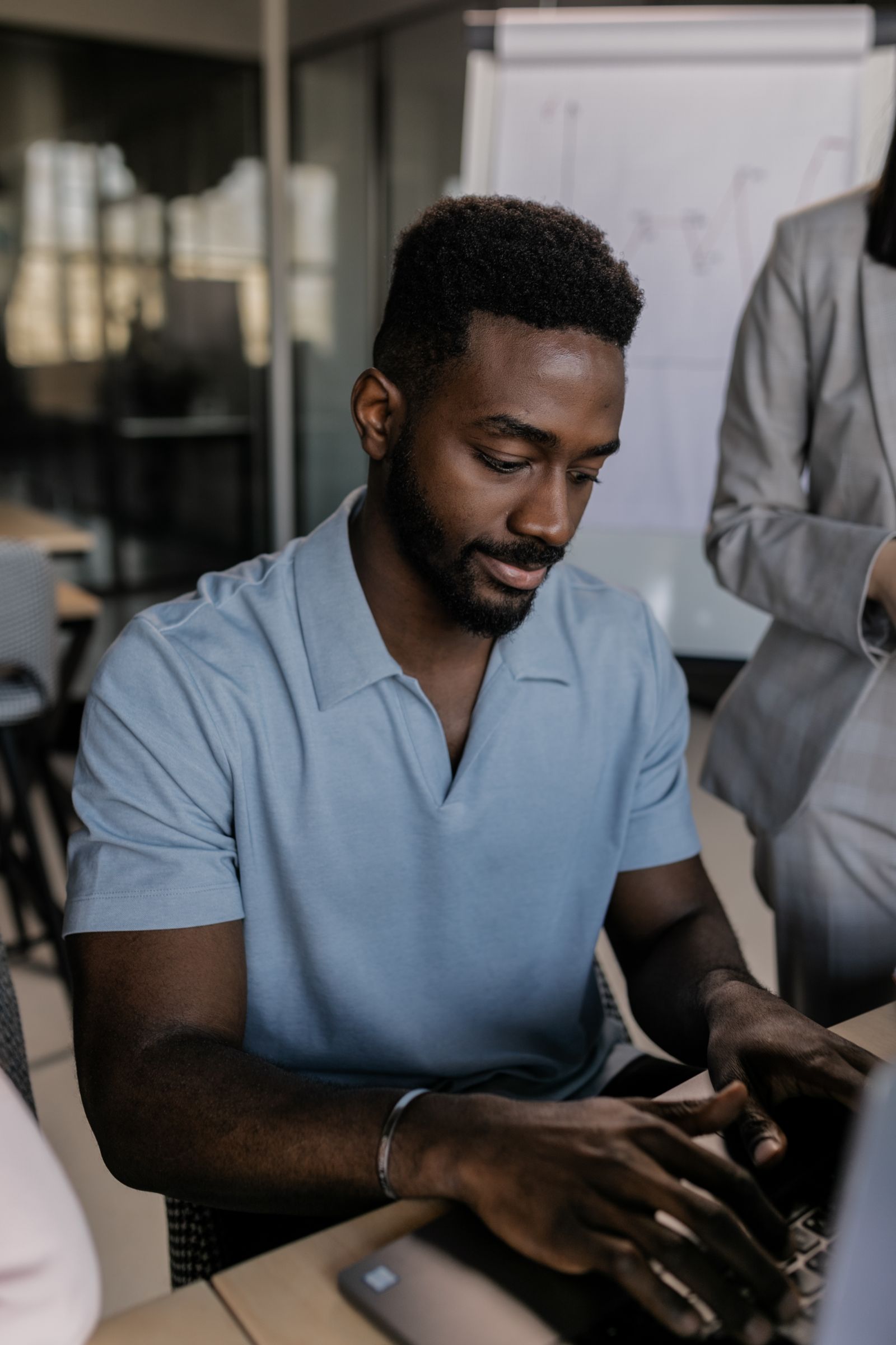 Black businessman reviewing documents and website requirements