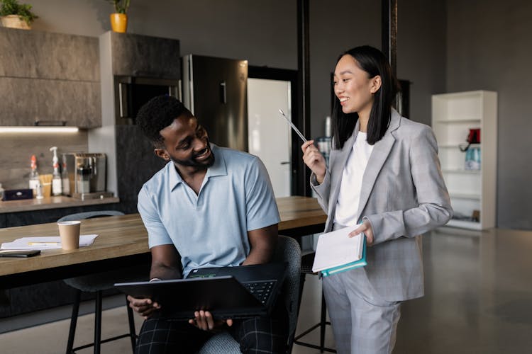 Smiling Coworkers Talking In The Office