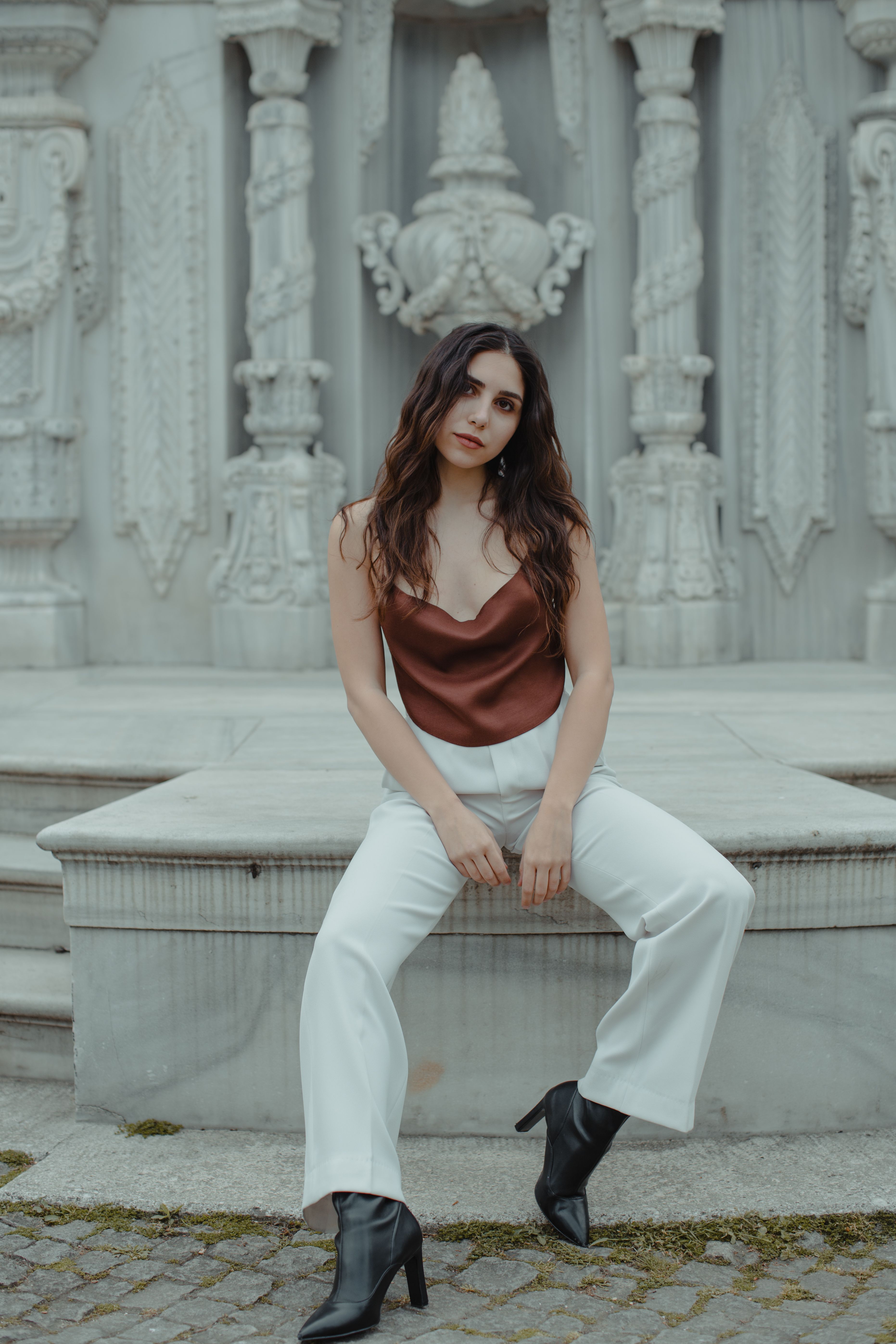 Woman in wide leg trousers with satin camisole