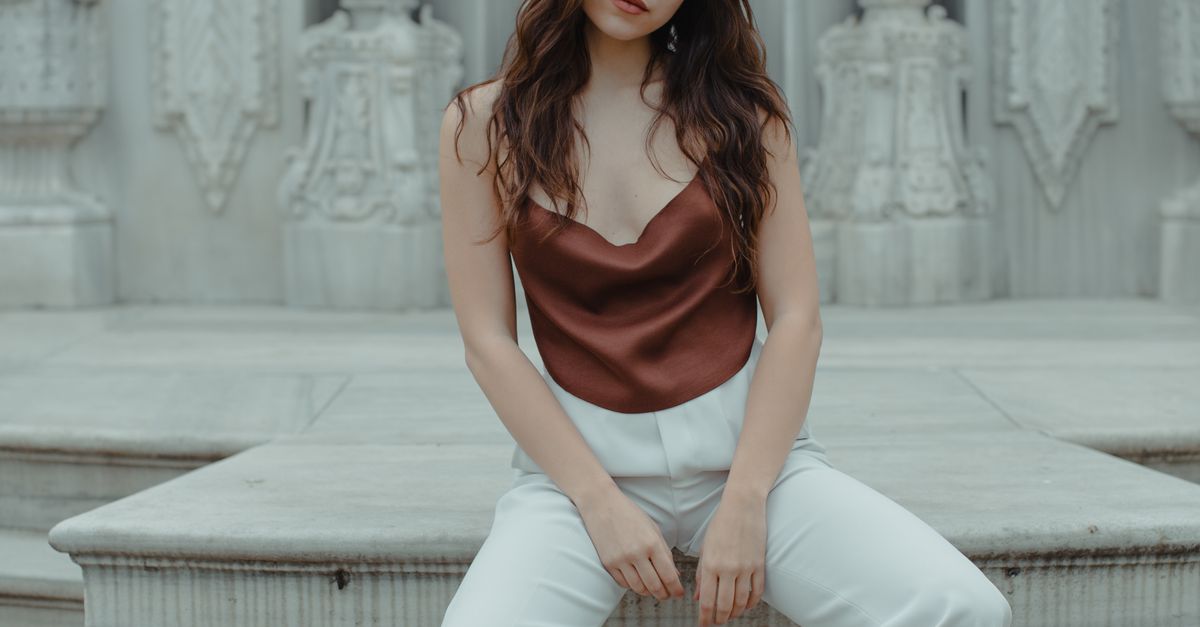 Woman in wide leg trousers with satin camisole