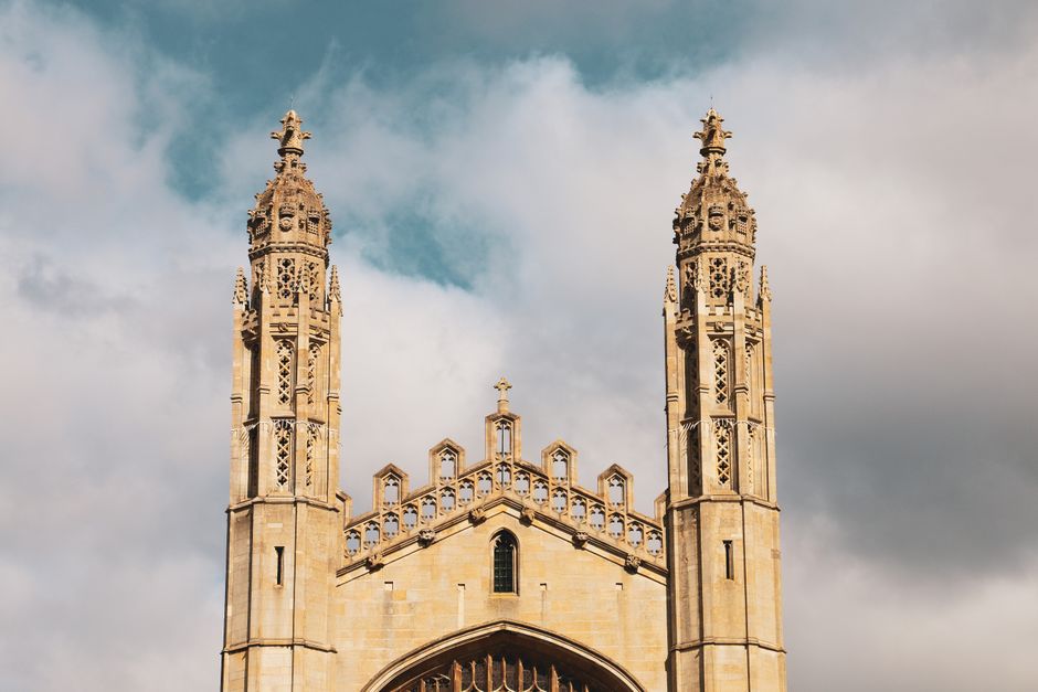 A stunning view of the twin towers of a historic cathedral against a cloudy sky.