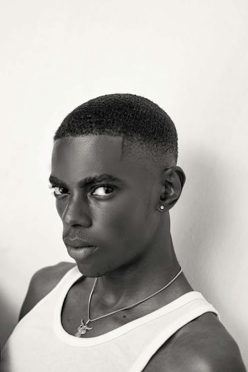 
A Grayscale of a Man Wearing a White Tank Top