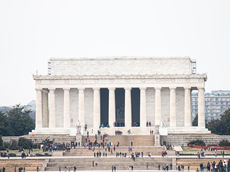 The iconic Lincoln Memorial surrounded by tourists on a day visit in Washington, DC - national register listings