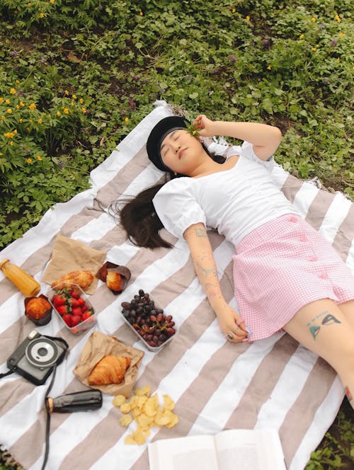 Free Woman Lying Down on Picnic Blanket Stock Photo