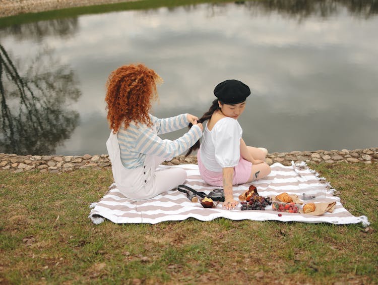 A Girl Braiding A Girl's Hair