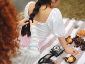 Woman in White Long Sleeve Shirt and White and Pink Striped Pants Sitting on Brown Dried