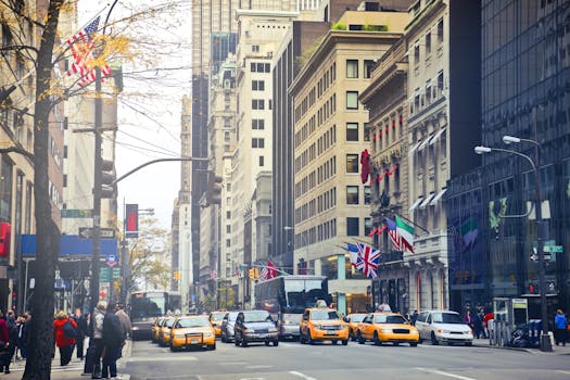 Busy New York City street with iconic taxis, buildings, and international flags