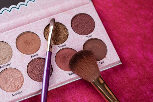 Free Make-up Brushes Beside the Eyeshadow Palette Stock Photo