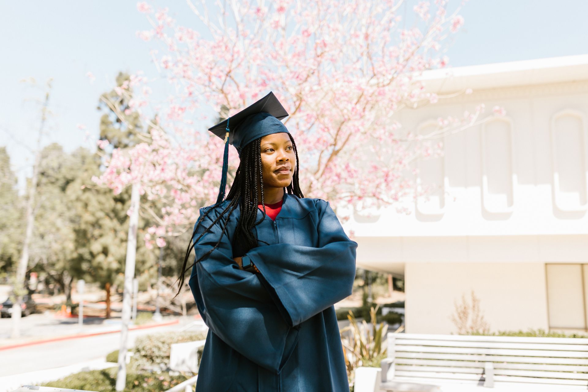 A Woman Wearing Graduation Uniform with Arms Folded