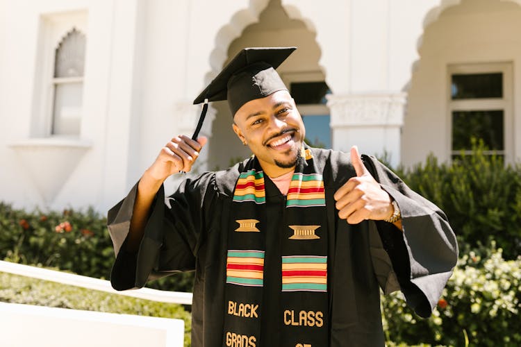 Man Wearing Graduation Cap Showing Thumbs Up