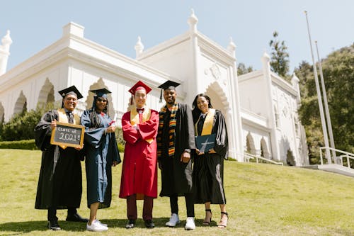 Free Men and Women Wearing Graduation Gowns Stock Photo